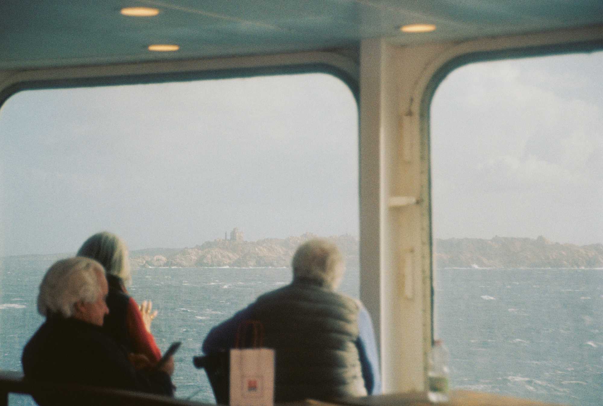 People seeing corsica from a ferry