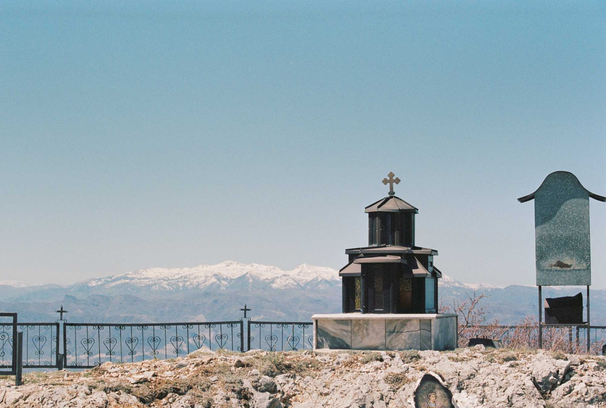 A crypt in front of a mountain range