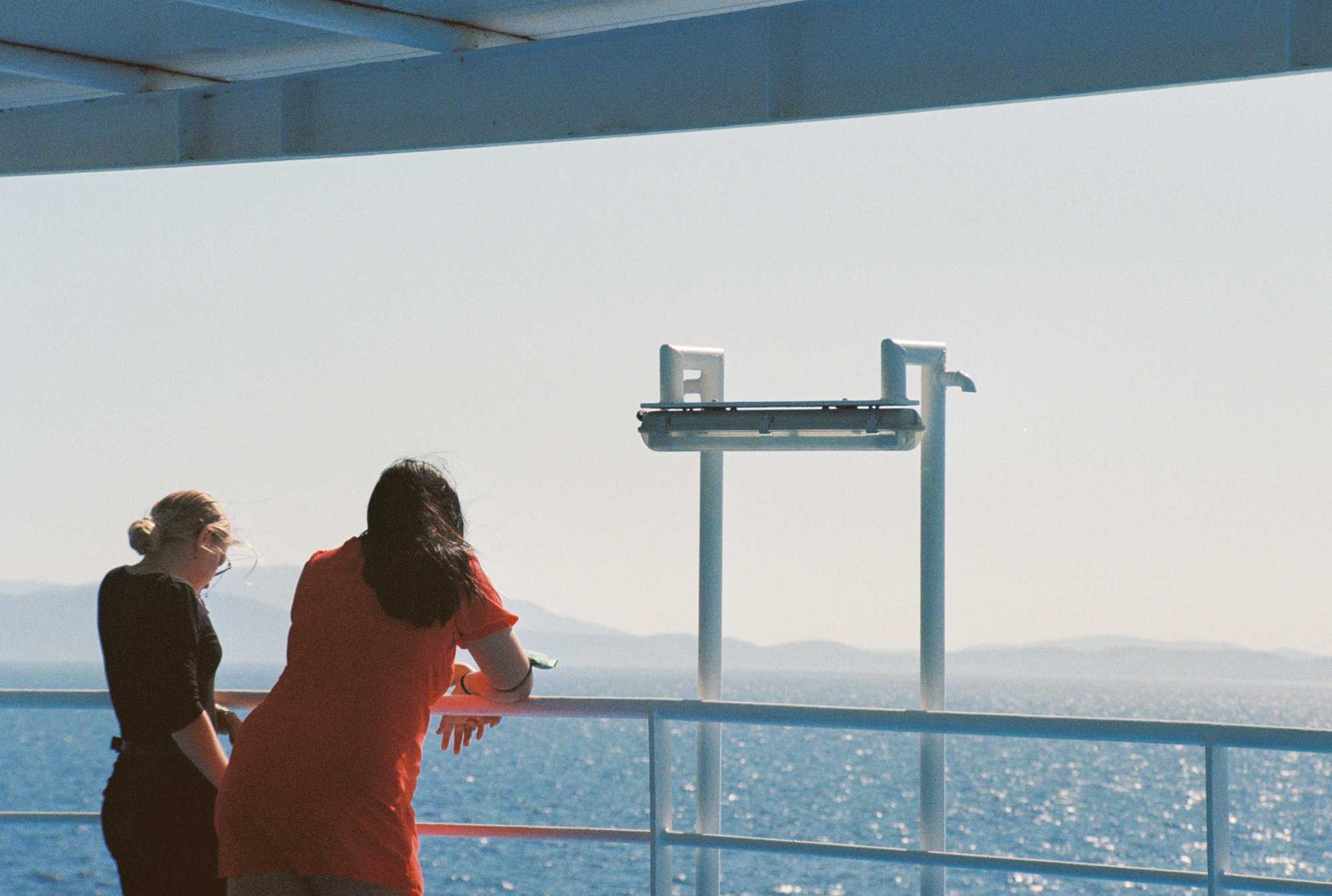 People talking on the edge of a ferry